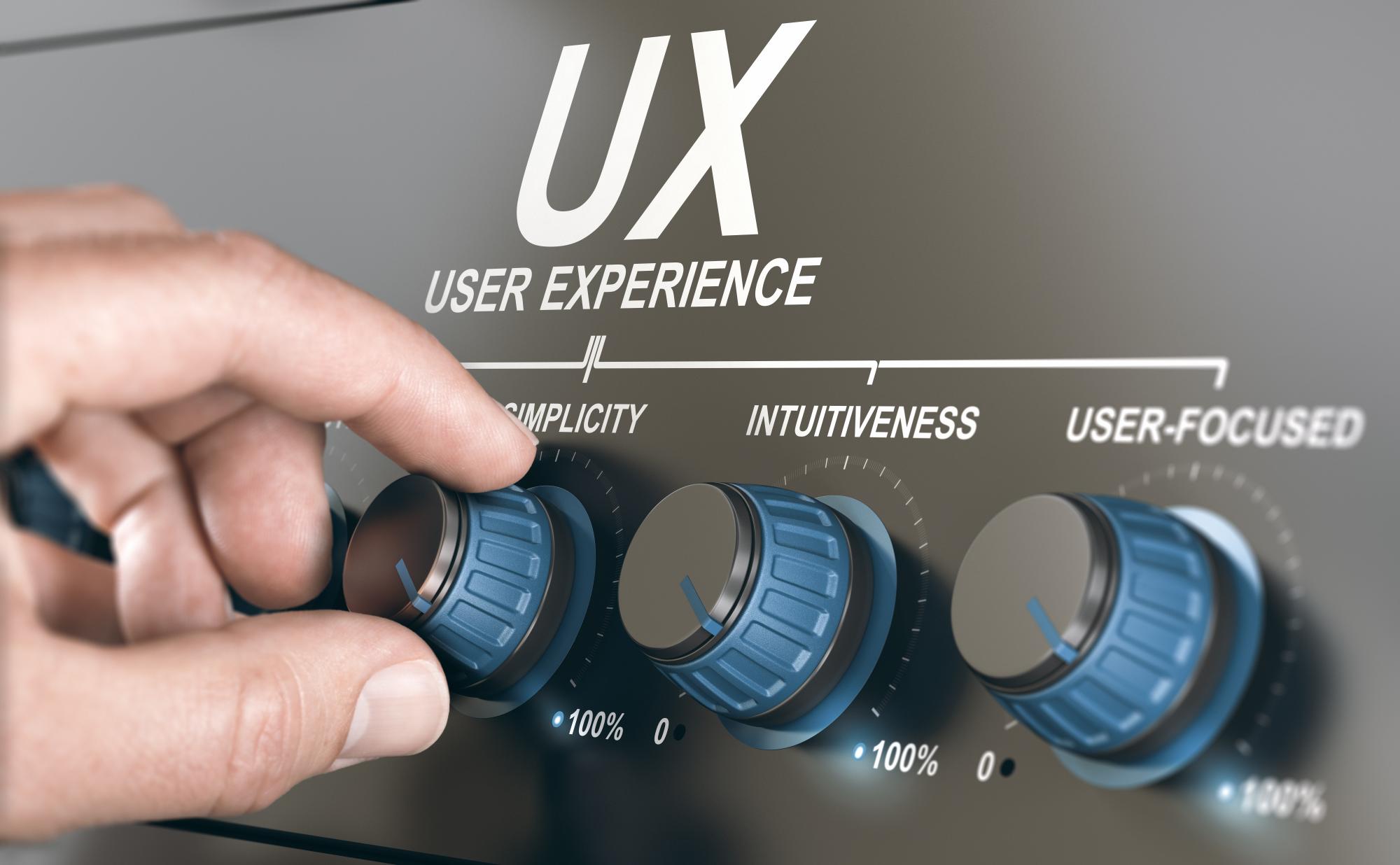 Photo of a hand turning knobs on a panel labeled user experience. The knobs labels are simplicity, intuitiveness, and user-focused. 